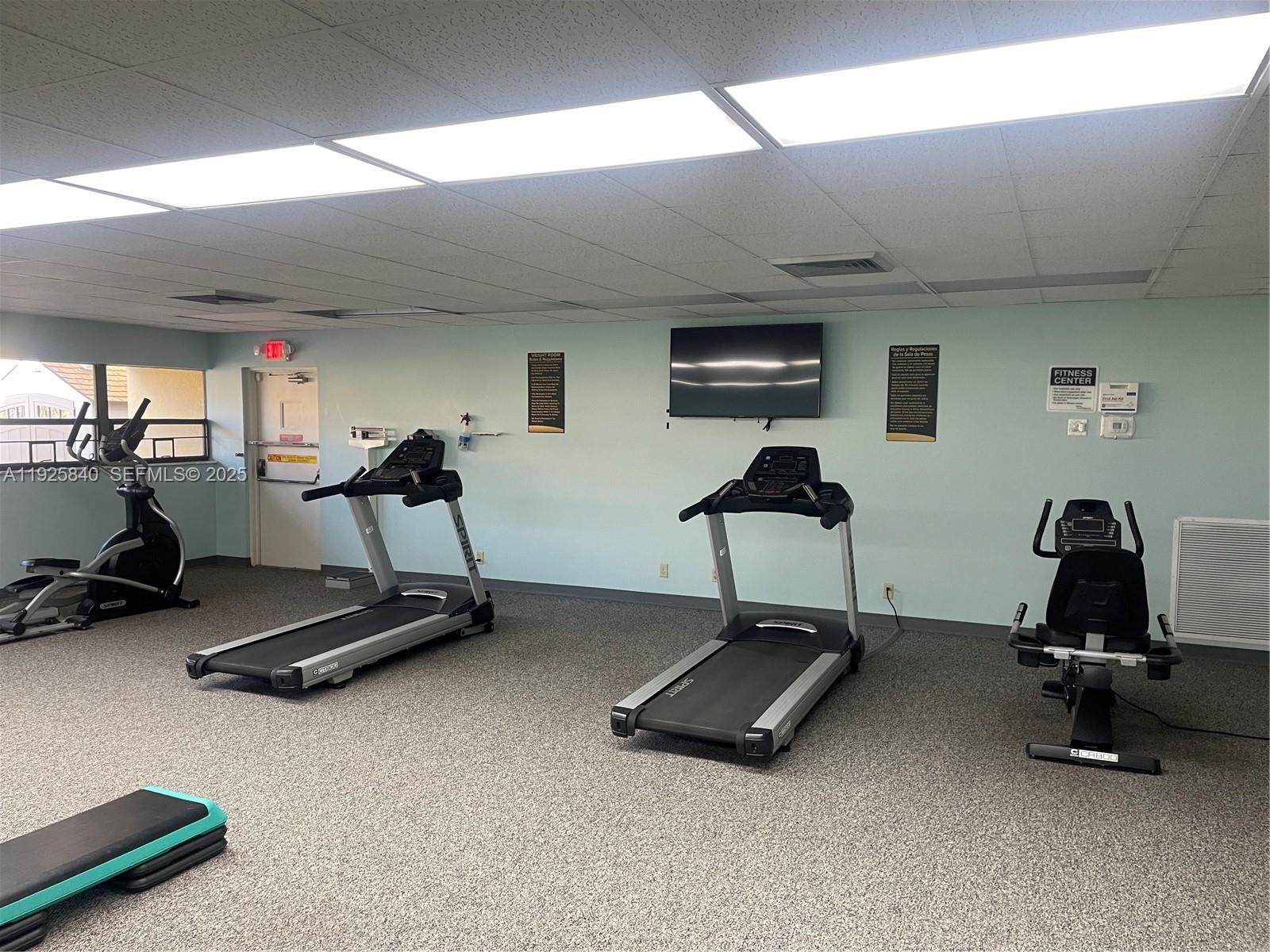 5961 Northwest 61st Avenue, Unit 208 Tamarac, FL 33319 - Photo 11 of 11 a room with gym equipment and a large window