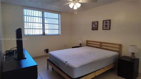 a bedroom with a bed and a desk
