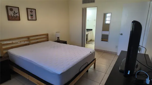 a view of a livingroom with furniture and a flat screen tv