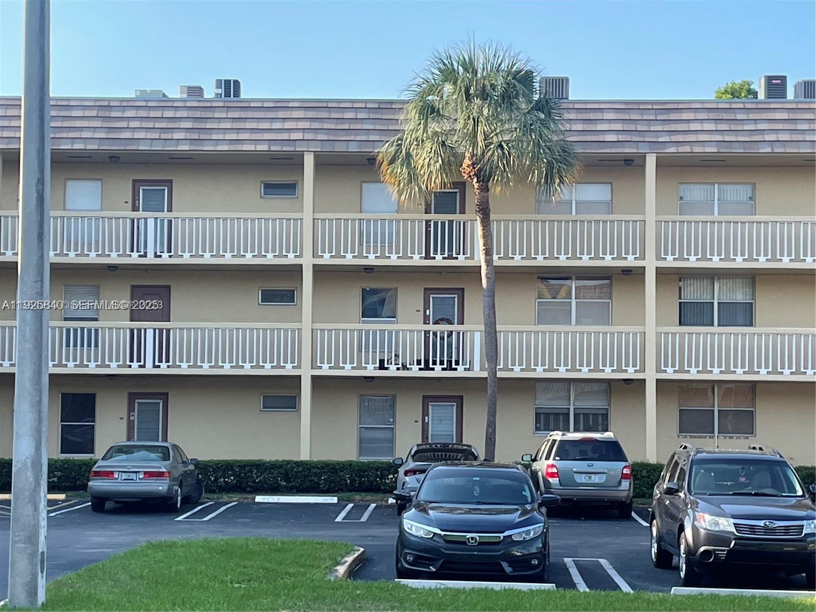 5961 Northwest 61st Avenue, Unit 208 Tamarac, FL 33319 - Photo 3 of 11 a car parked in front of a house