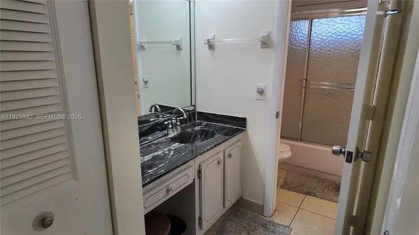 a white toilet sitting next to a sink