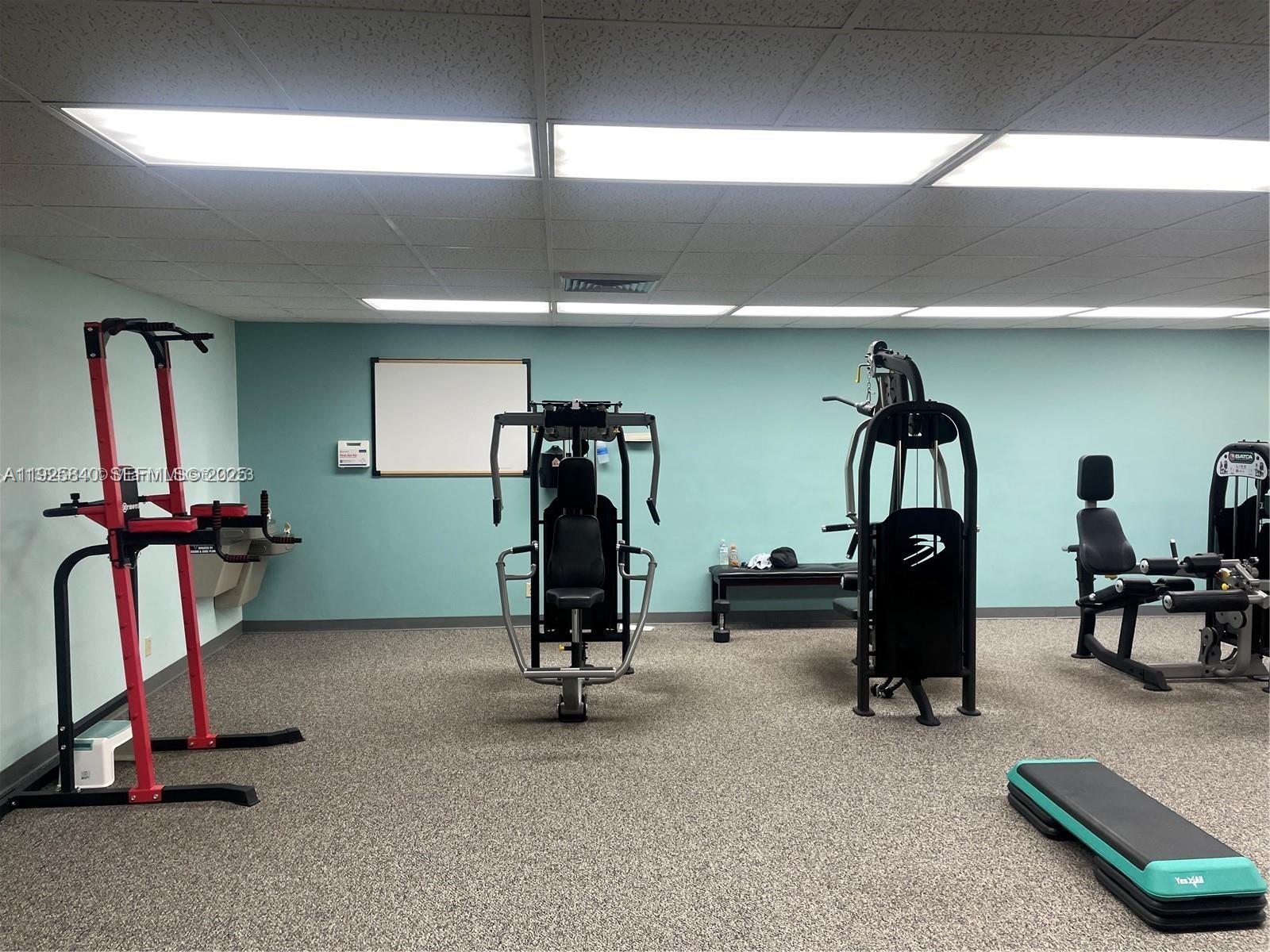 5961 Northwest 61st Avenue, Unit 208 Tamarac, FL 33319 - Photo 10 of 11 a view of a room with gym equipment