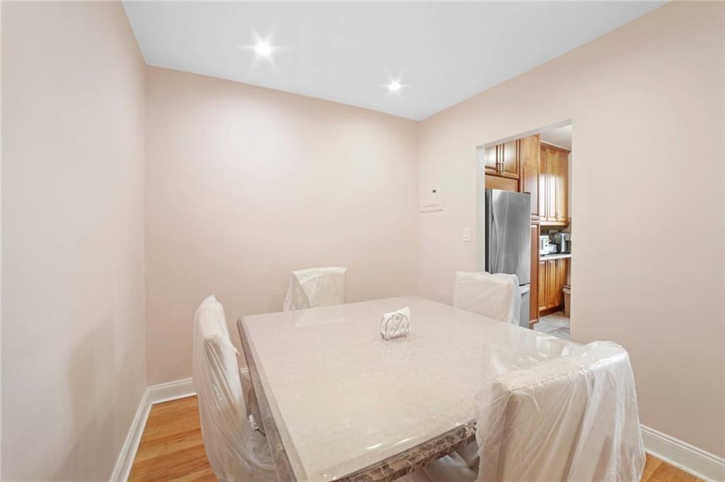 2310 Ocean Parkway, Unit 3J Brooklyn, NY 11223 - Photo 3 of 8 a dining room with a sink and a mirror