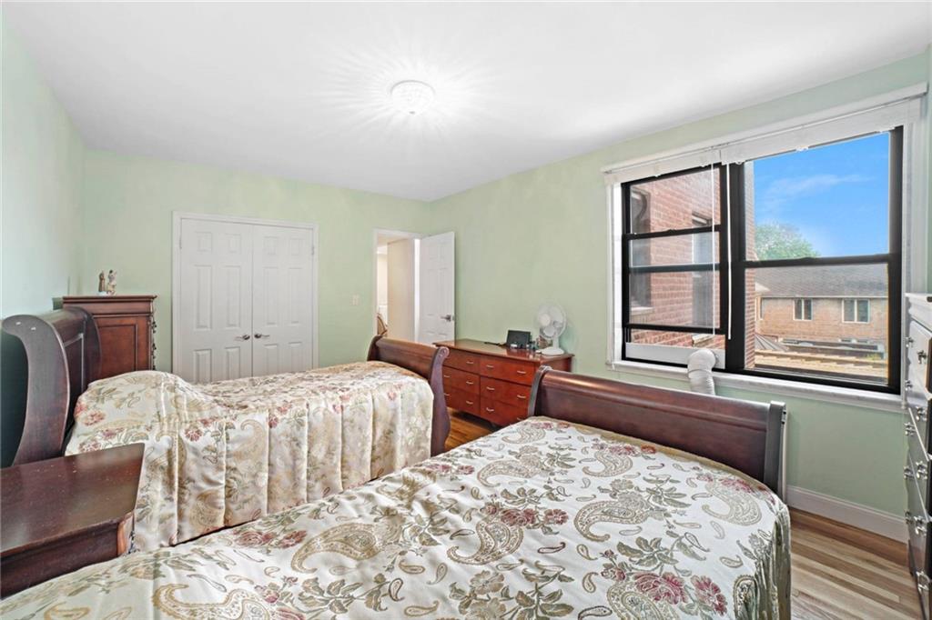 2310 Ocean Parkway, Unit 3J Brooklyn, NY 11223 - Photo 6 of 8 a bedroom with two beds and a large window