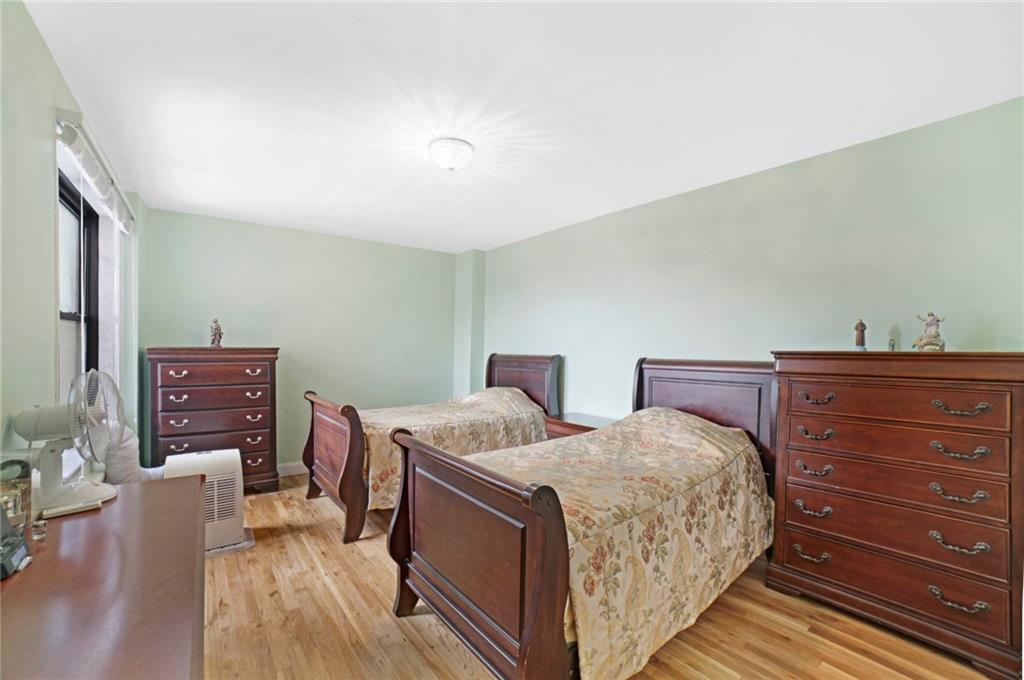 2310 Ocean Parkway, Unit 3J Brooklyn, NY 11223 - Photo 7 of 8 a bed room with two bed and a chair