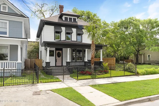 a front view of a house with a garden