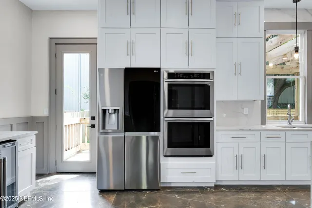 a kitchen with stainless steel appliances a refrigerator and a stove