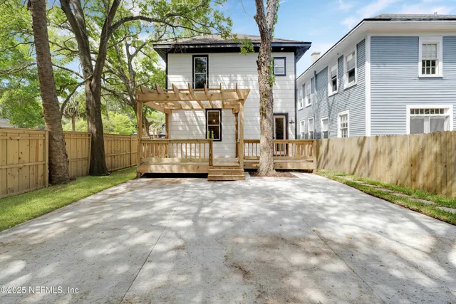 a view of a house with a wooden fence