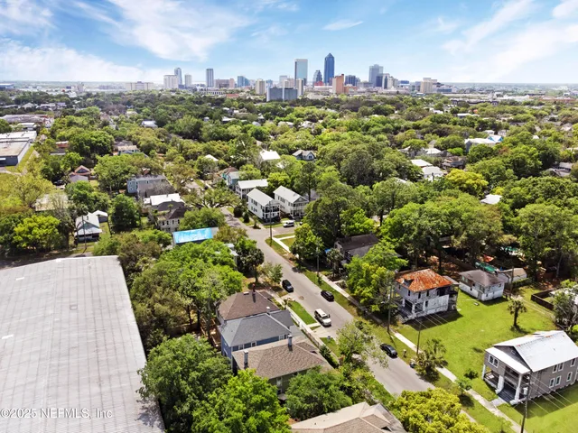 an aerial view of residential houses with outdoor space