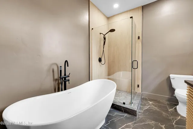 a bathroom with a bathtub and shower