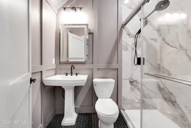 a bathroom with a sink toilet and shower