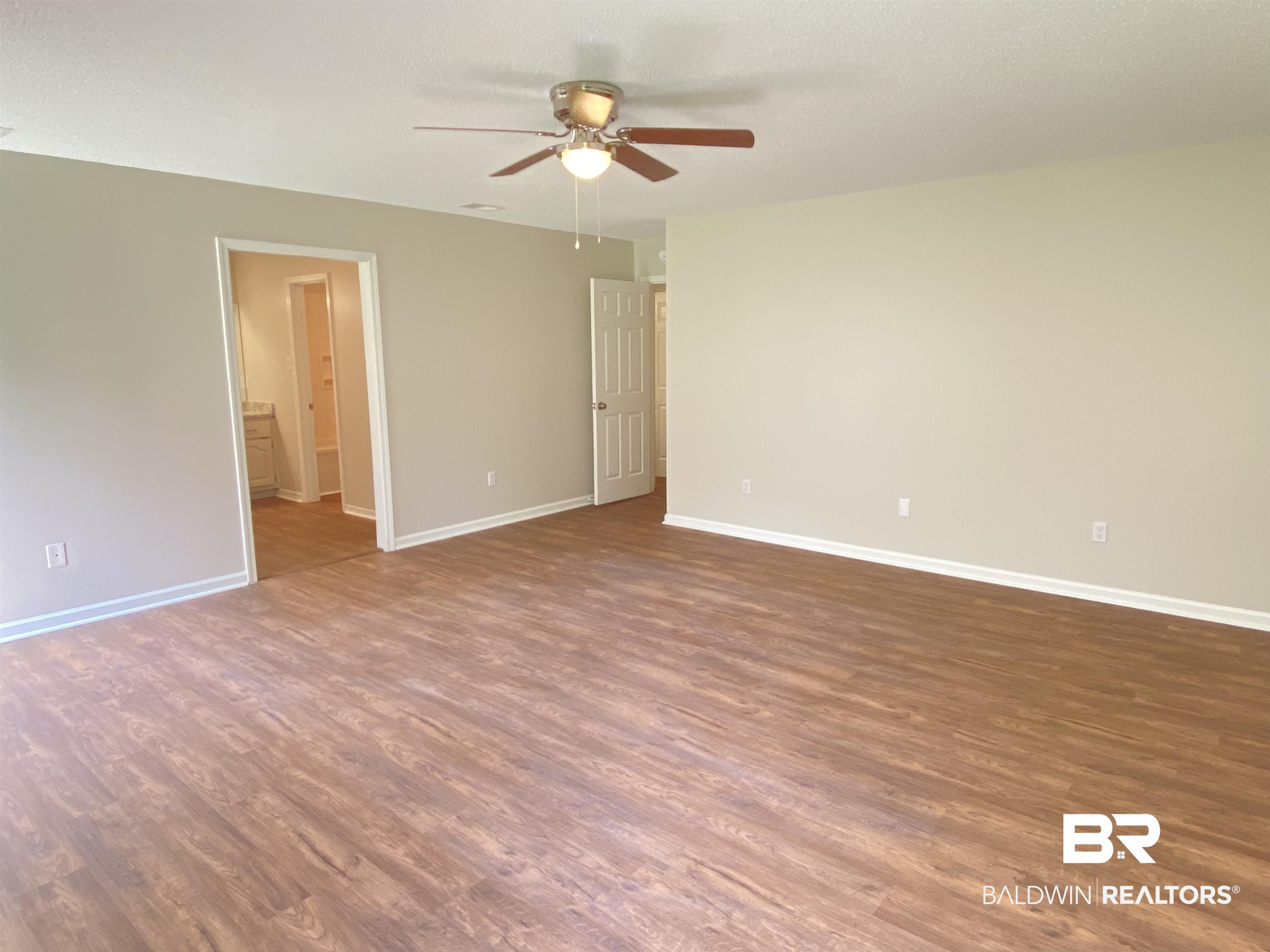 12150 Lee Bishop Road Irvington, AL 36544 - Photo 15 of 26 Spare room featuring a ceiling fan, baseboards, and wood finished floors