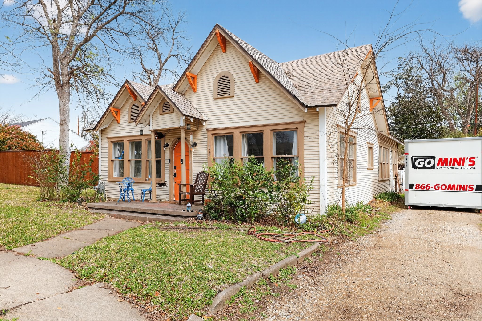 1017 North 11th Street Temple, TX 76501 - Photo 4 of 25 a view of a white house with a yard and lawn chairs under a large tree