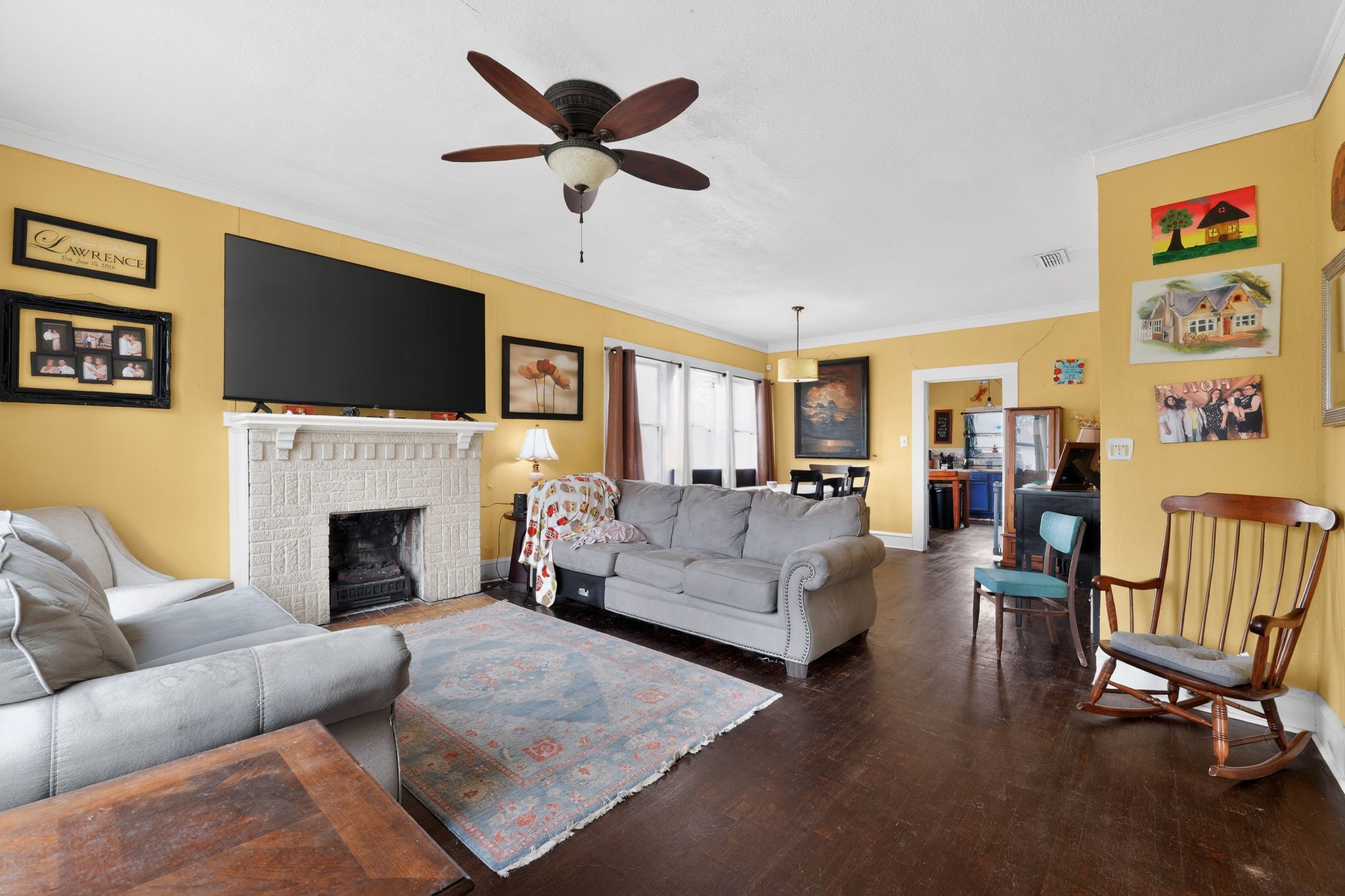 1017 North 11th Street Temple, TX 76501 - Photo 6 of 25 a living room with furniture a flat screen tv and a fireplace