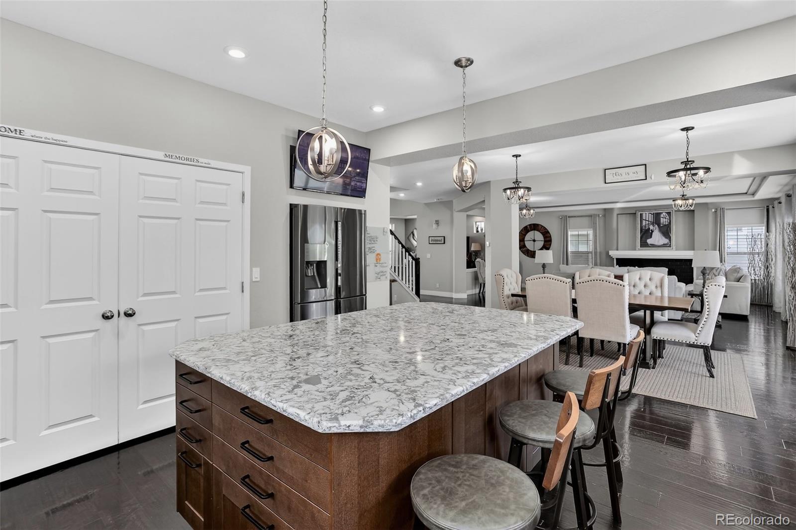 5012 Liverpool Street Denver, CO 80249 - Photo 13 of 49 a kitchen with stainless steel appliances granite countertop a kitchen island a stove a table and chairs