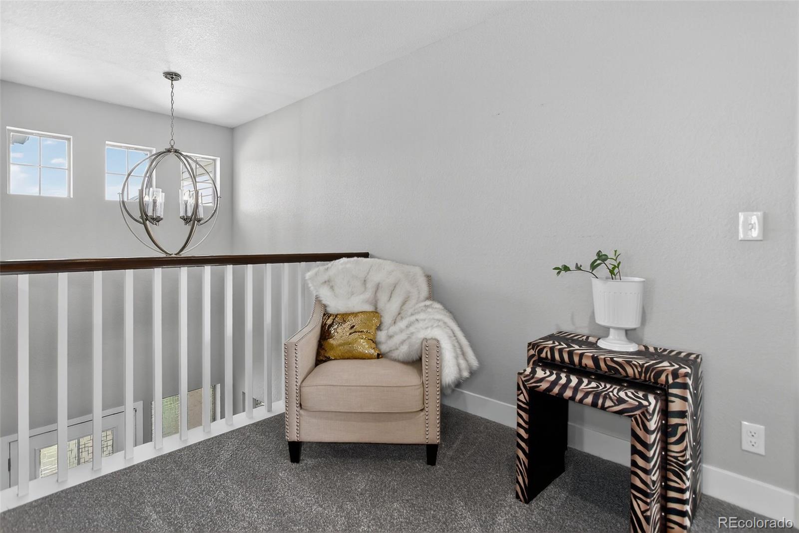 5012 Liverpool Street Denver, CO 80249 - Photo 20 of 49 a bedroom with a bed and a chair