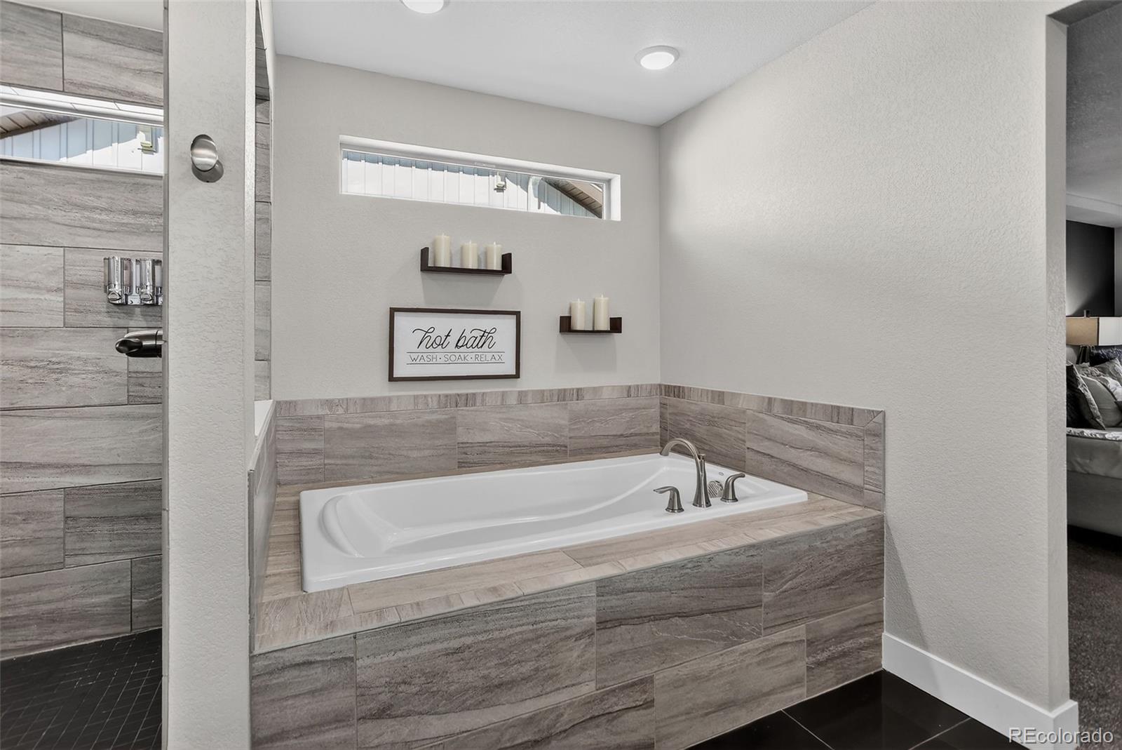 5012 Liverpool Street Denver, CO 80249 - Photo 24 of 49 a bathroom with bathtub and shower