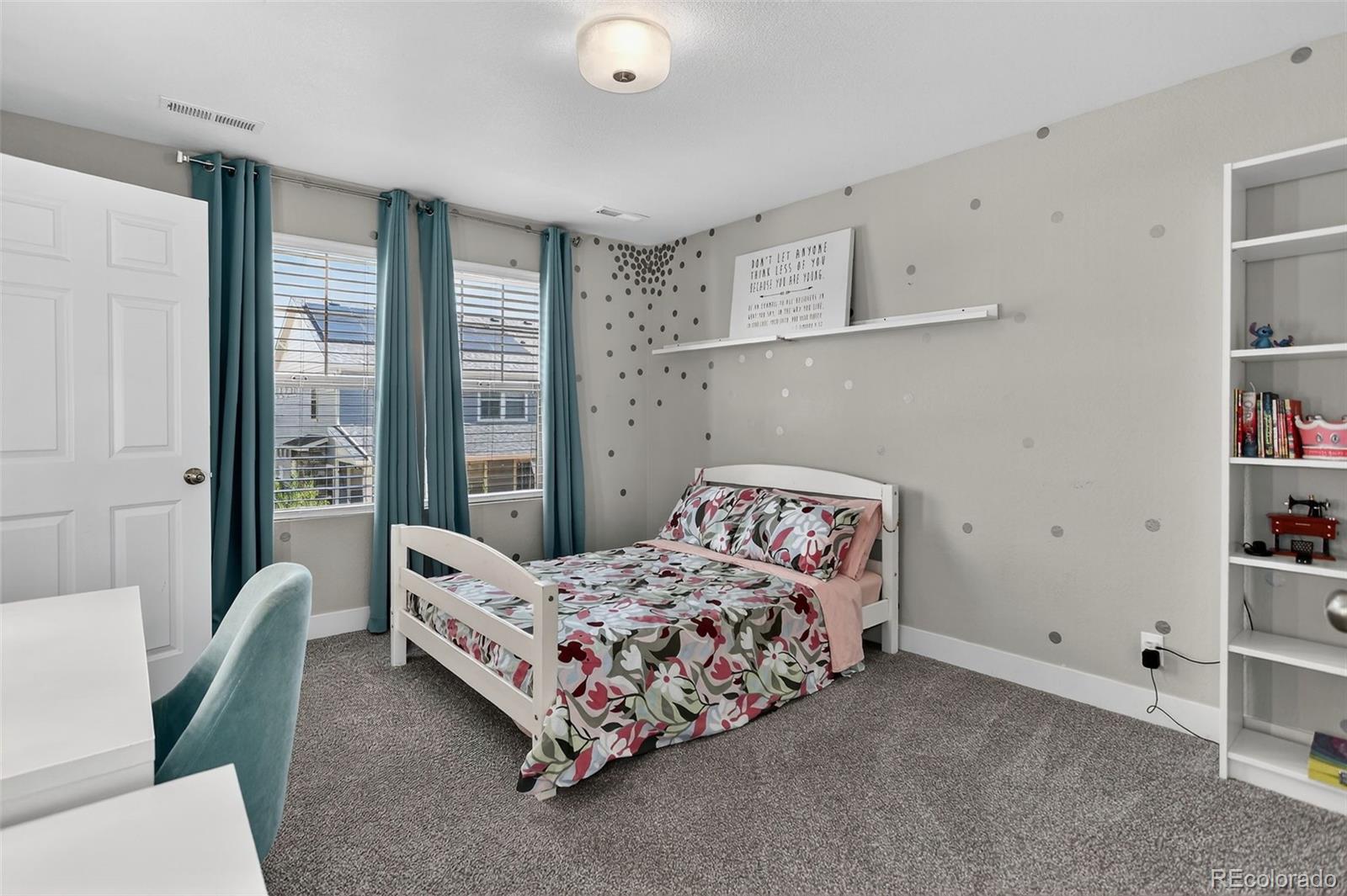 5012 Liverpool Street Denver, CO 80249 - Photo 27 of 49 a bedroom with a bed couch and a window