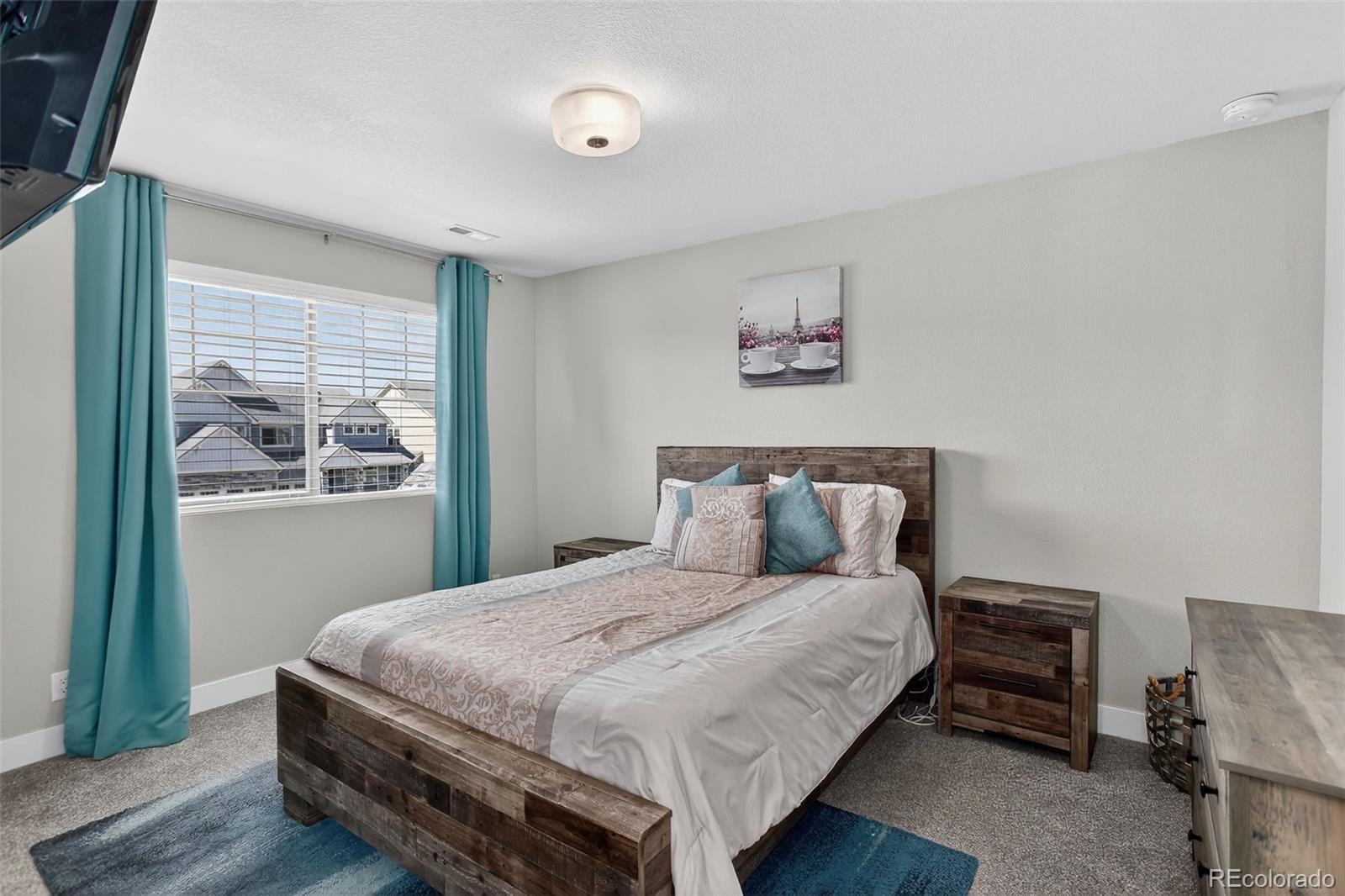 5012 Liverpool Street Denver, CO 80249 - Photo 28 of 49 a large bed sitting in a bedroom next to a window