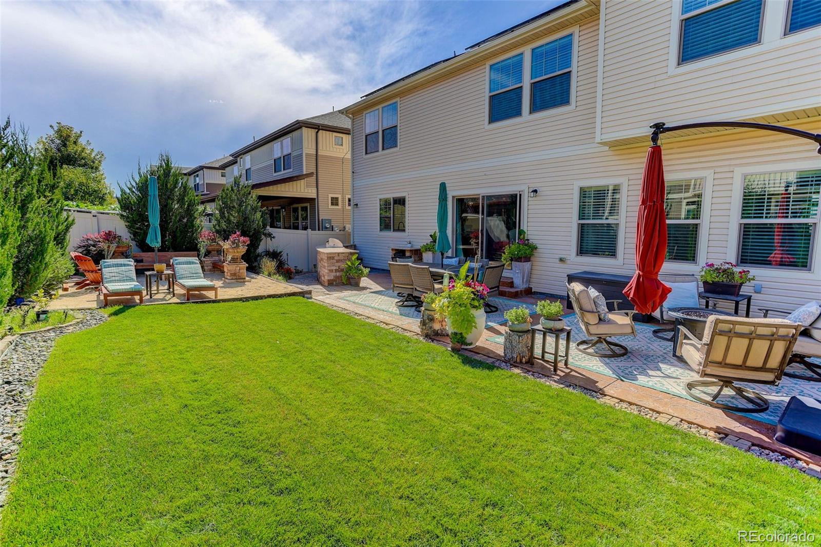 5012 Liverpool Street Denver, CO 80249 - Photo 40 of 49 a backyard of a house with outdoor seating