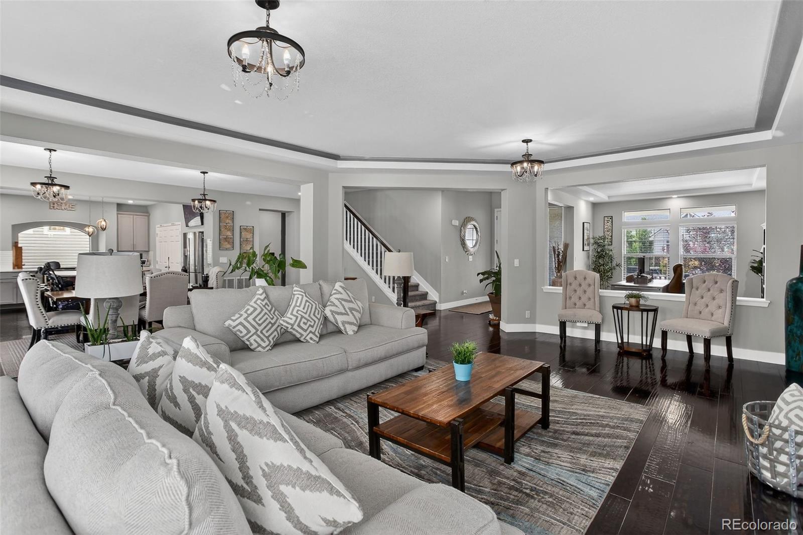 5012 Liverpool Street Denver, CO 80249 - Photo 4 of 49 a living room with furniture and wooden floor
