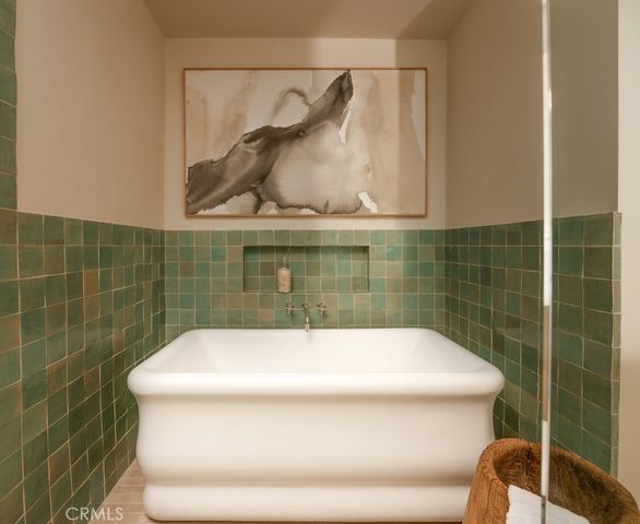 a bathroom with a toilet a sink a mirror and shower