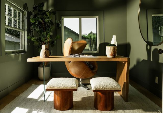 a living room with furniture a flat screen tv and a large window