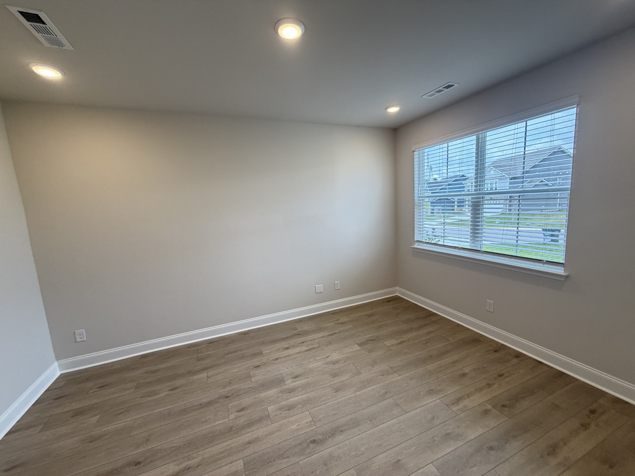 147 Emeline Way Mount Juliet, TN 37122 - Photo 6 of 41 an empty room with wooden floor and windows
