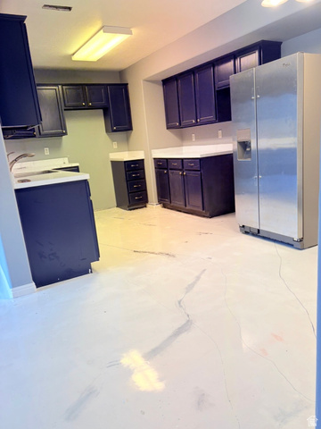 8116 North Ridge Loop West, Unit 8 Eagle Mountain, UT 84005 - Photo 6 of 23 Kitchen with stainless steel fridge with ice dispenser, light countertops, and concrete flooring