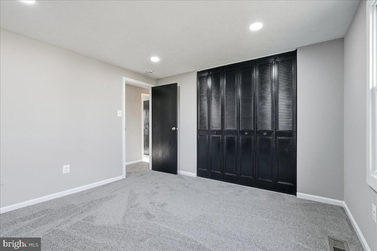 427 Heather Ridge Drive Frederick, MD 21702 - Photo 11 of 18 an empty room with wooden floor and entryway