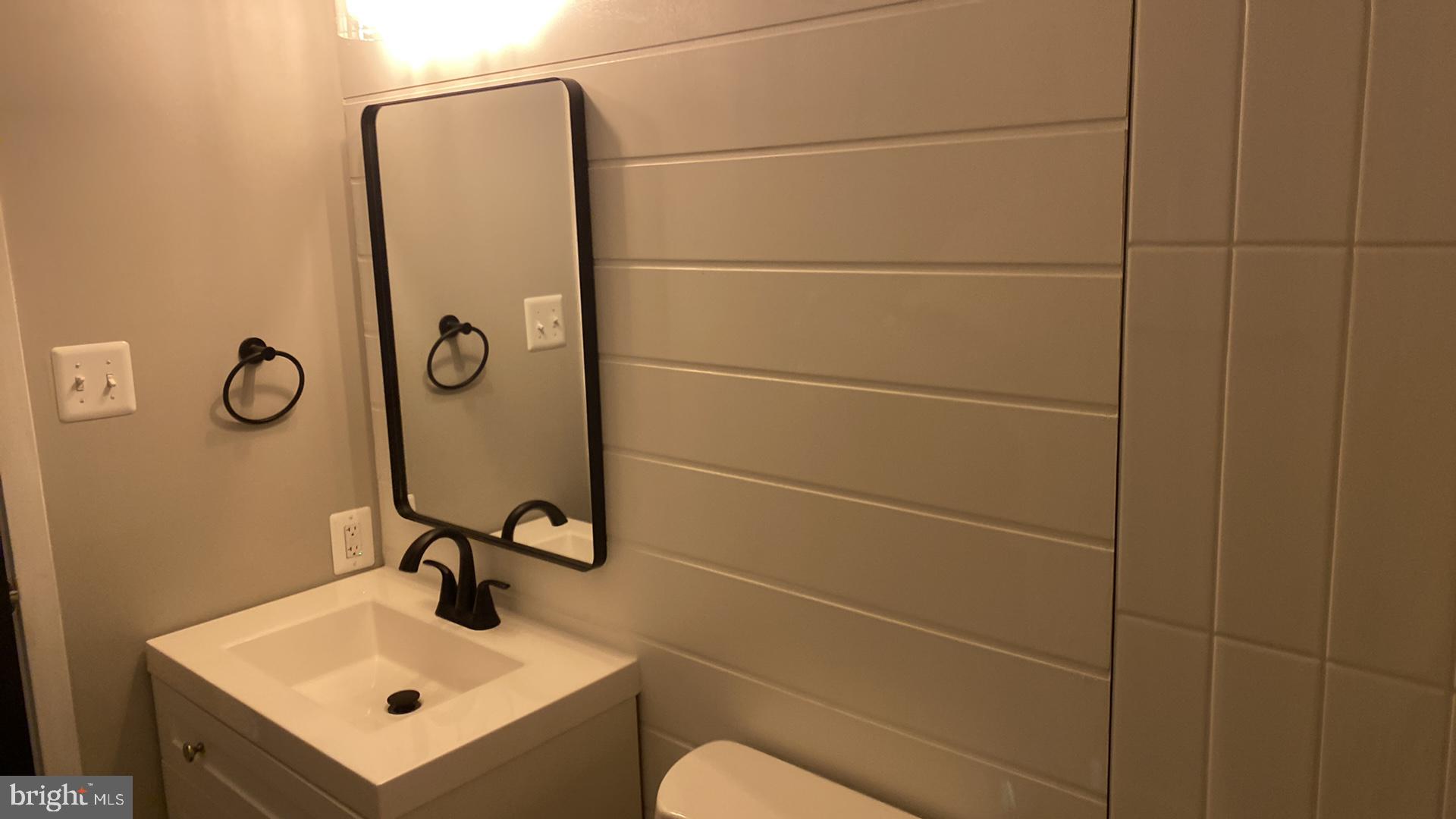 427 Heather Ridge Drive Frederick, MD 21702 - Photo 13 of 17 a bathroom with a sink toilet and mirror