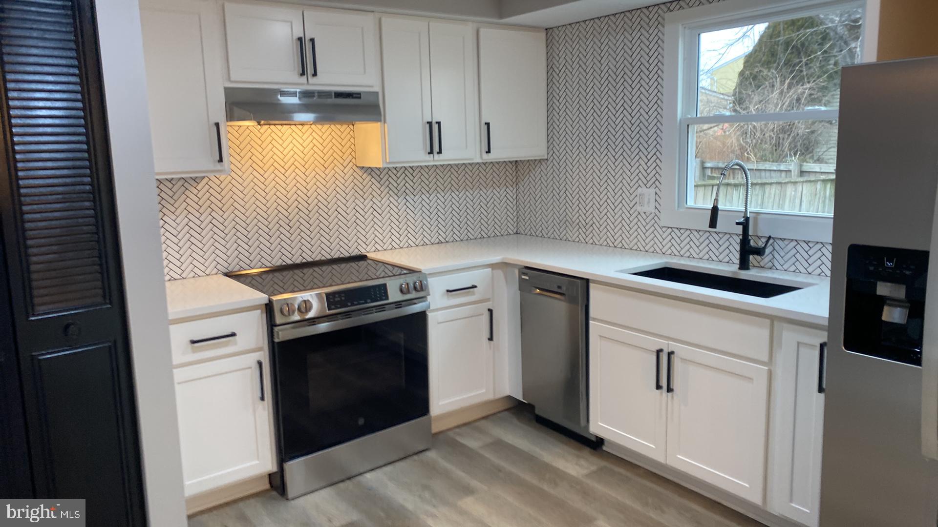 427 Heather Ridge Drive Frederick, MD 21702 - Photo 2 of 17 a kitchen with a sink stove and cabinets