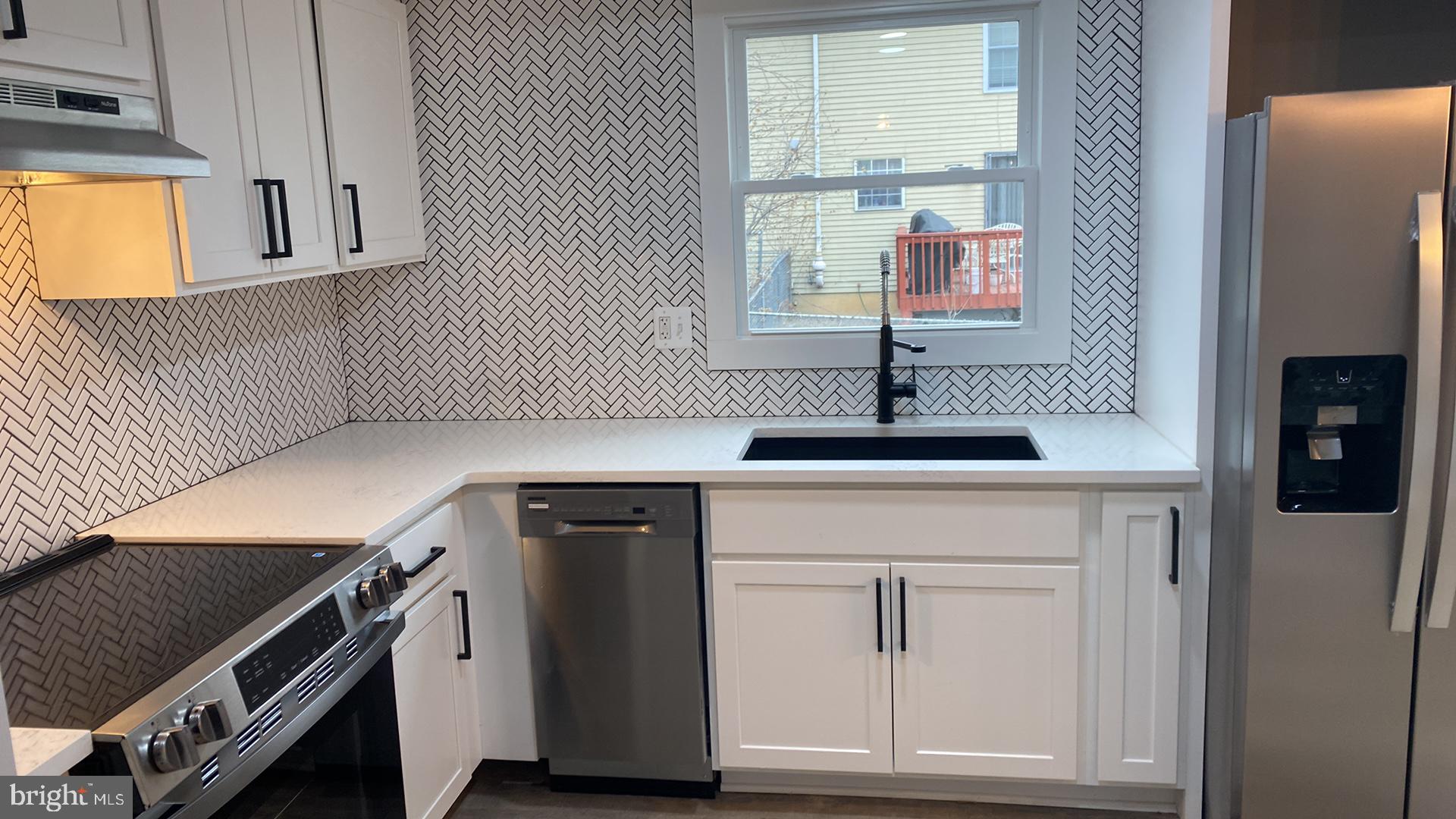 427 Heather Ridge Drive Frederick, MD 21702 - Photo 3 of 17 a kitchen with a sink cabinets and a window