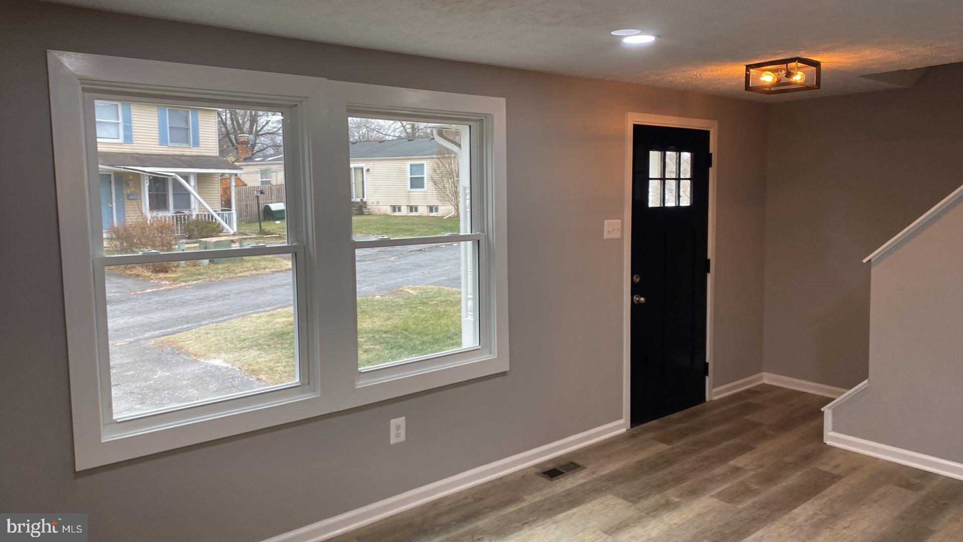 427 Heather Ridge Drive Frederick, MD 21702 - Photo 5 of 17 a view of an empty room with wooden floor and a window