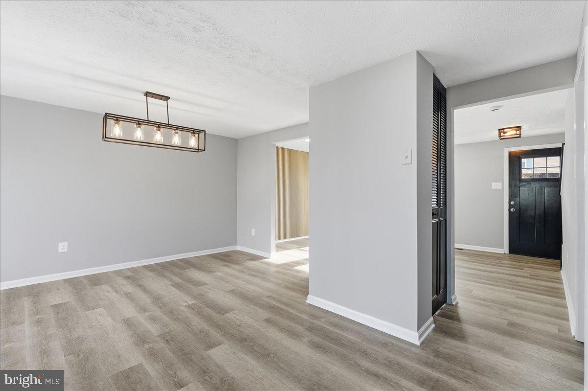 427 Heather Ridge Drive Frederick, MD 21702 - Photo 10 of 18 an empty room with wooden floor and windows