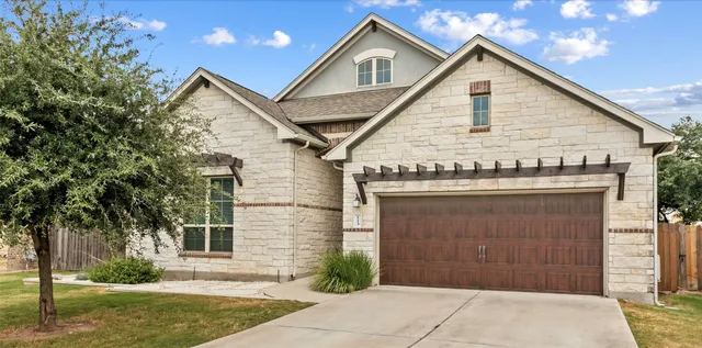 a view of a house with a yard and garage