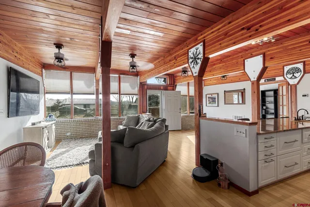 a living room with furniture and large windows