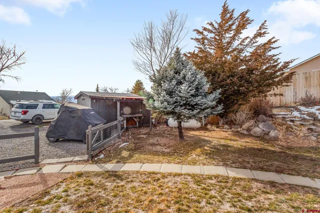a view of a yard with car parked