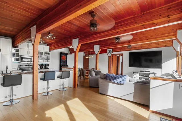 a living room with furniture and flat screen tv