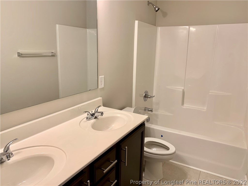 939 Montrose Road Raeford, NC 28376 - Photo 22 of 25 a bathroom with a sink a toilet and shower