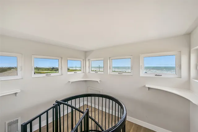 a view of a balcony with wooden floor