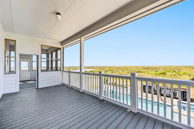 a view of a balcony with wooden floor