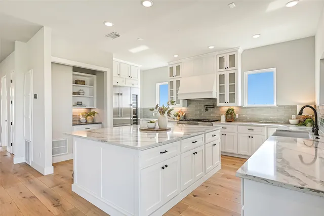 a kitchen with center island appliances and cabinets