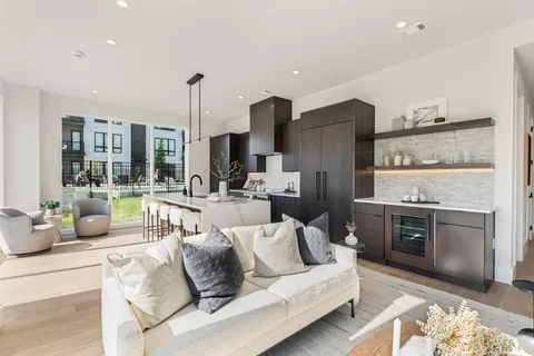 a living room with furniture and kitchen view