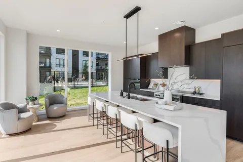 a work room with furniture and a potted plant