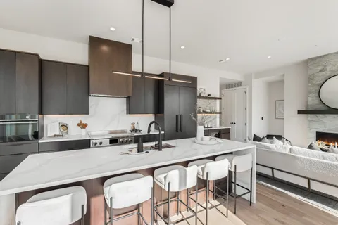 a kitchen with a table chairs stove and refrigerator