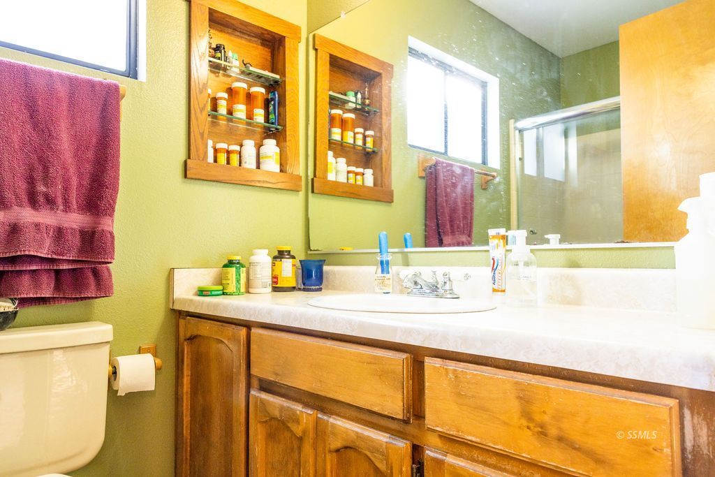 834 West Graaf Avenue Ridgecrest, CA 93555 - Photo 29 of 39 a bathroom with a granite countertop sink and a mirror