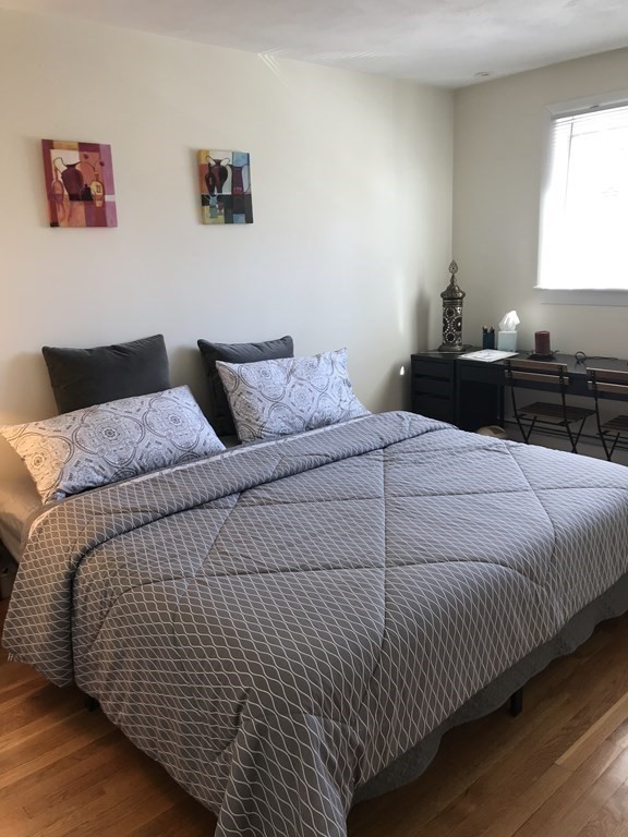 132 Brandeis Road Newton, MA 02459 - Photo 6 of 10 a bedroom with a bed and a night stand