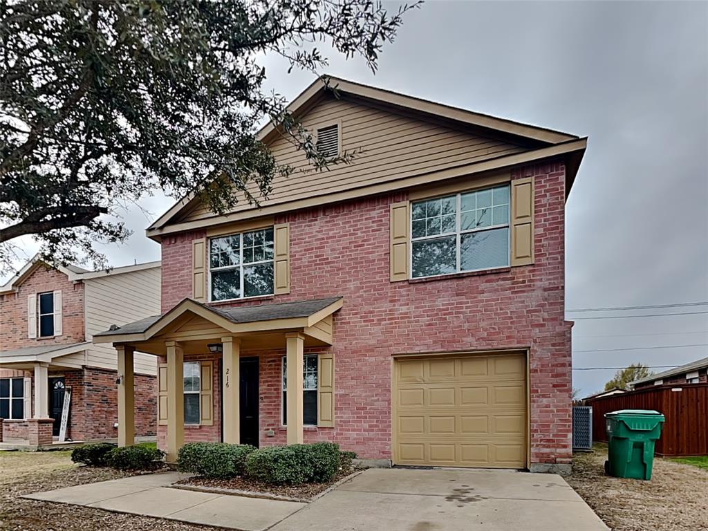 216 Turning Tree Road Wilmer, TX 75172 - Photo 1 of 20 View of front facade featuring brick siding, concrete driveway, a garage, and covered porch
