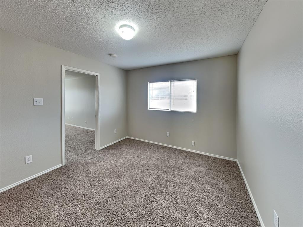 216 Turning Tree Road Wilmer, TX 75172 - Photo 16 of 20 Empty room with carpet and a textured ceiling